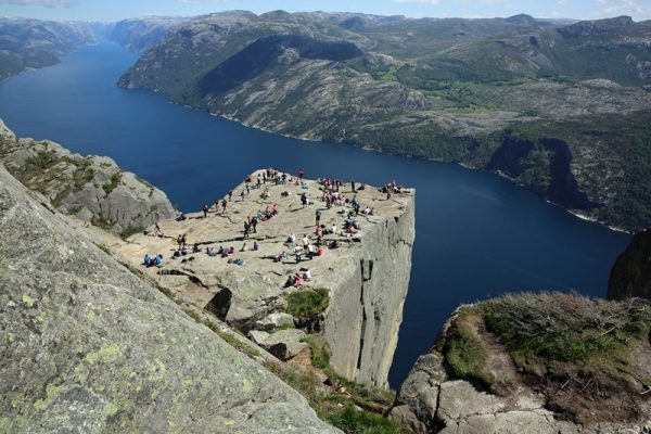 NORWAY - JUNE 16, 2014: Unidentified group of tourists enjoy a wonderful day at Pulpit Rock (Preikestolen) above the Lysefjord in Norway