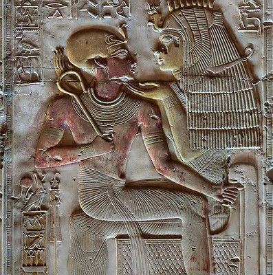 [Egypt 29866]
�Isis and the young Seti at Abydos.�

	This relief shows Isis caressing pharaoh Seti I as a child. She says to him: �You are my son, you have come forth from me, I have nursed you, in order to be Ruler of the Two Lands.� Sitting in the lap of Isis, Seti has taken the role of Horus, Isis� child.
Behind the pharaoh we see his Horus name (Powerful Bull in Thebes), written within a rectangle (a �serekh�) on which a falcon is perched. The rectangle is held by Seti�s �ka� (life f